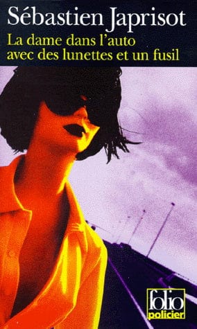 La dame dans l'auto avec des lunettes et un fusil
